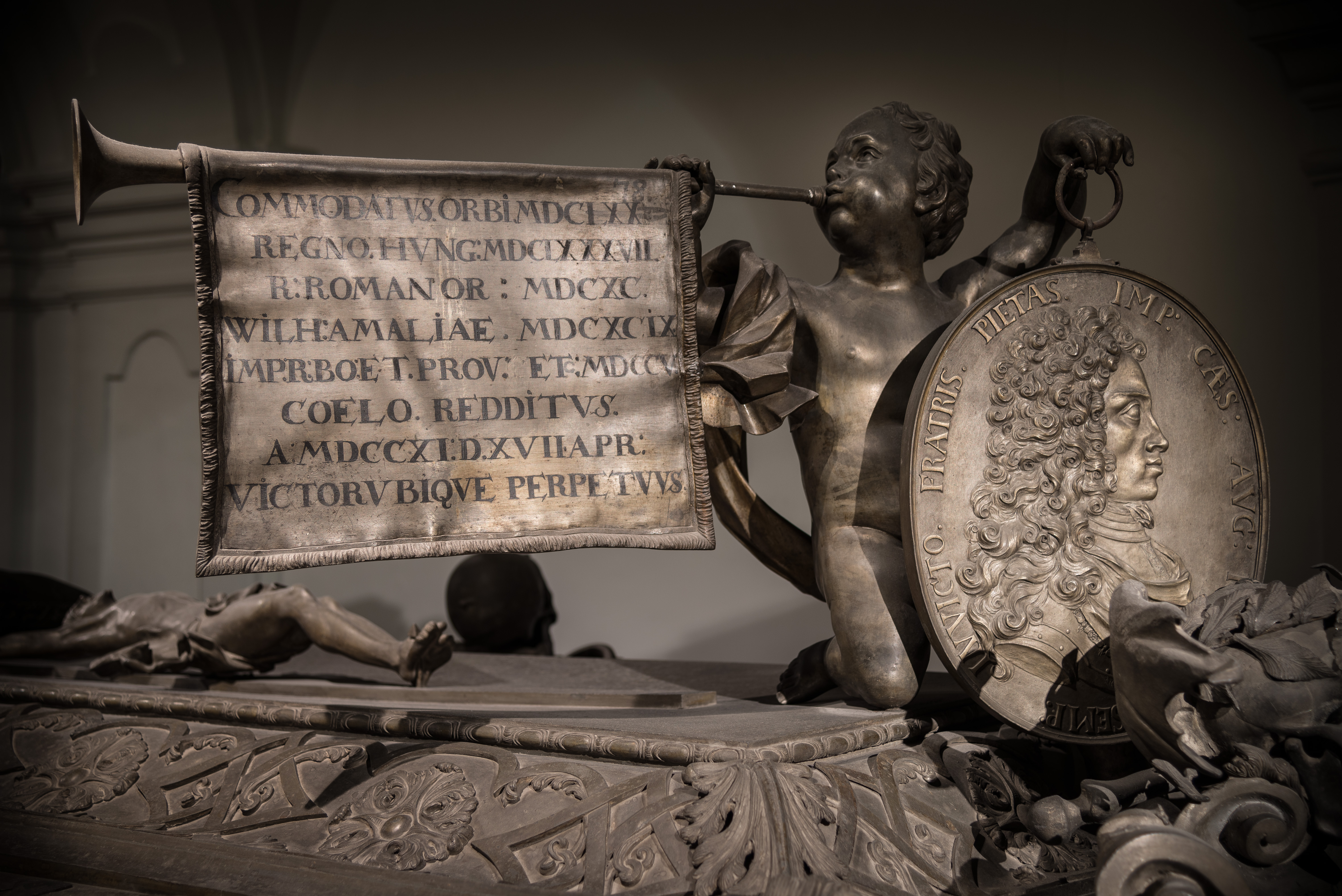 Detailansicht des Sarkophags von Joseph I. mit Engel und Porträtmedaillon.